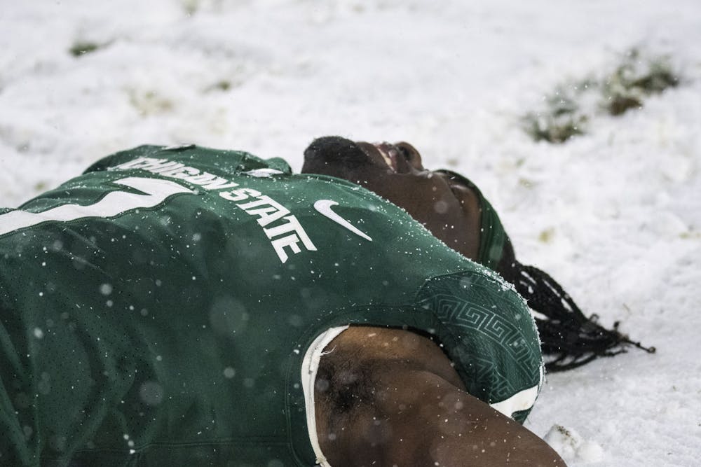 <p>Reed celebrates the win against the Penn State Nittany Lions with snow angels at Spartan Stadium on Saturday, Nov. 27, 2021. </p>