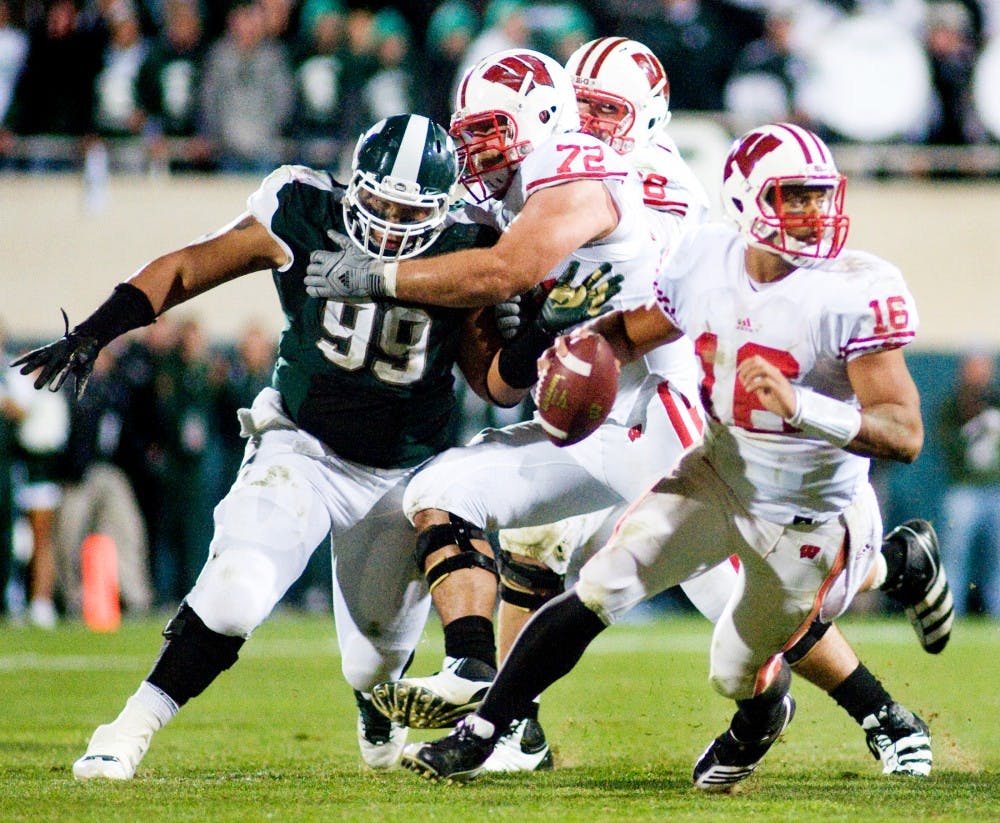 Wisconsin quarterback Russell Wilson looks for a throw as junior defensive tackle Jerel Worthy attempts to fight off blocks by Wisconsin players. The Spartans defeated the Badgers, 37-31, Saturday night at Spartan Stadium. Justin Wan/The State News