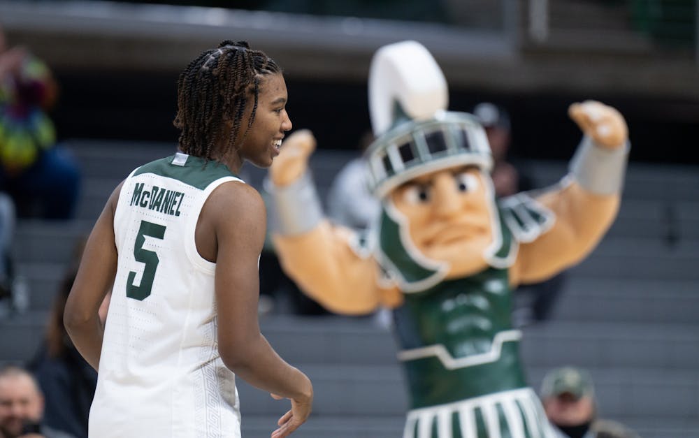 <p>MSU Mascot Sparty hypes up the crowd as guard Kamaria McDaniel crosses the floor to kiss the Spartan head logo at the center of the court at the Breslin Center in East Lansing on Wednesday, Feb. 22, 2023. McDaniel, from Inkster, Michigan, came to MSU this season after two seasons at Baylor University.</p>