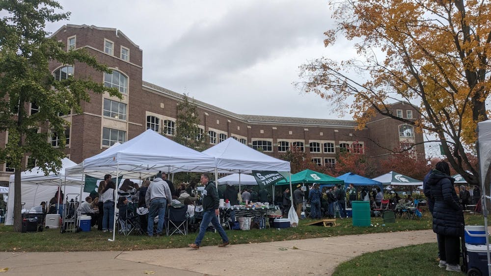 Tailgate events fill the courtyard of the parking ramp beside Michigan State's Olin Health Center.