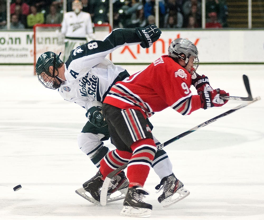	<p>Ohio State forward Chad Niddery loses his balance after running into senior forward Chris Forfar. The Buckeyes defeated the Spartans, 3-1, Saturday, Dec. 1, 2012, at Munn Ice Arena. Justin Wan/The State News</p>