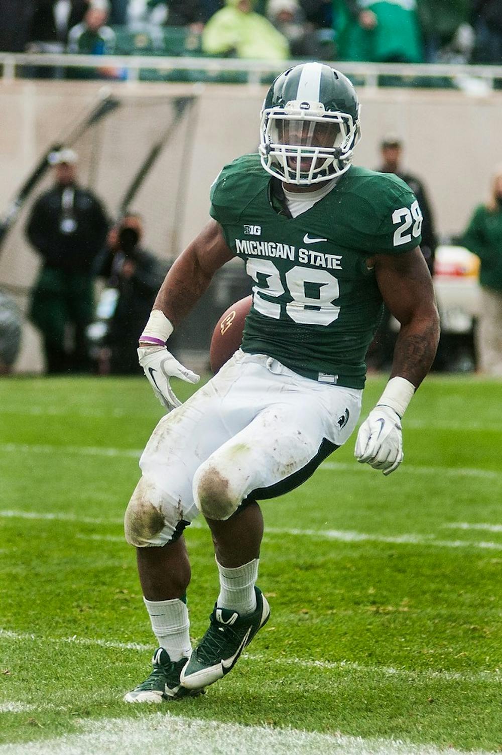 	<p>Senior linebacker Denicos Allen runs into the end zone for a touchdown after picking up a fumble during the game against Purdue, Oct. 19, 2013, at Spartan Stadium. The Spartans defeated the Boilermarkers, 14-0. Danyelle Morrow/The State News</p>