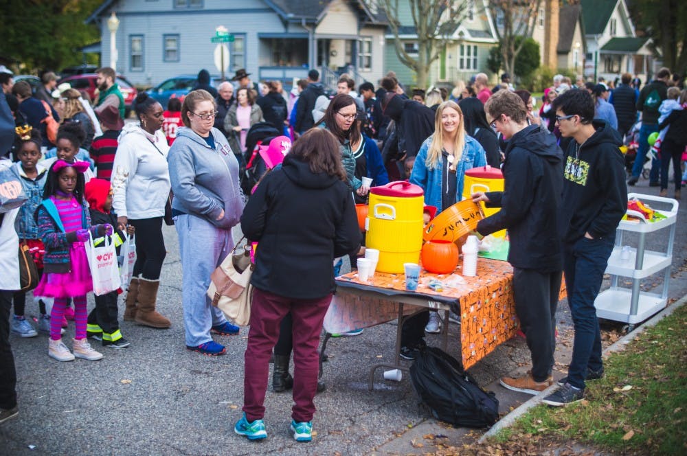Kids wait in line for cider during the Safe Halloween event on Oct. 26, 2017, on M.A.C. Ave. Safe Halloween is an event put on by MSU Greek life to provide kids with a fun and safe trick-or-treating experience.