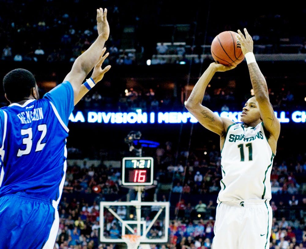 Sophomore guard Keith Appling takes a shot with St. Louis defenders in his face  Sunday afternoon at Nationwide Arena, Columbus, Ohio. Appling was the Spartan high-scorer with 19 points in the 65-61 Spartan victory over the St. Louis Billikens. Jaclyn McNeal/The State News. 