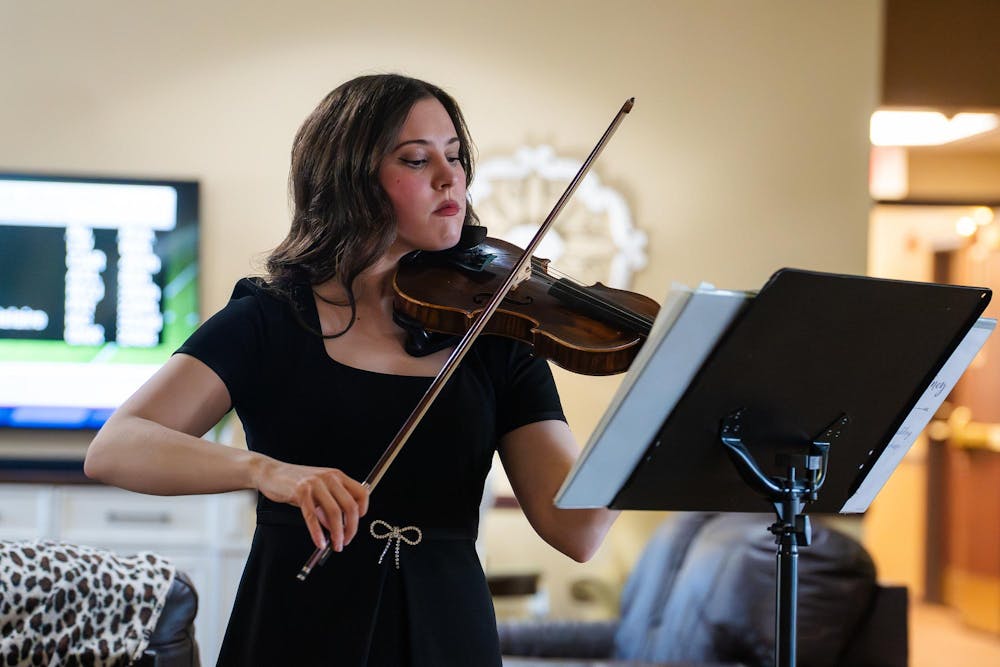 <p>Sydney Penrose, president of the MSU chapter of Music for Dementia, plays violin for assisted living residents at Bickford of Okemos in Okemos, Michigan on Tuesday, April 8, 2026.</p>