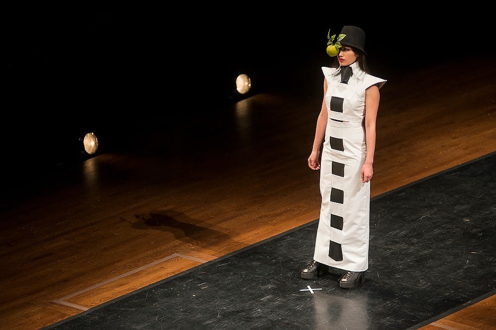 <p>Apparel and textile design senior Kyla Curtis showcases her dress titled Daughter of Man on Mar. 6, 2015, during the Apparel and Textile Design Fashion Show at the Wharton Center. ATD students design and constuct original garments for months before the show. Emily Nagle/The State News</p>