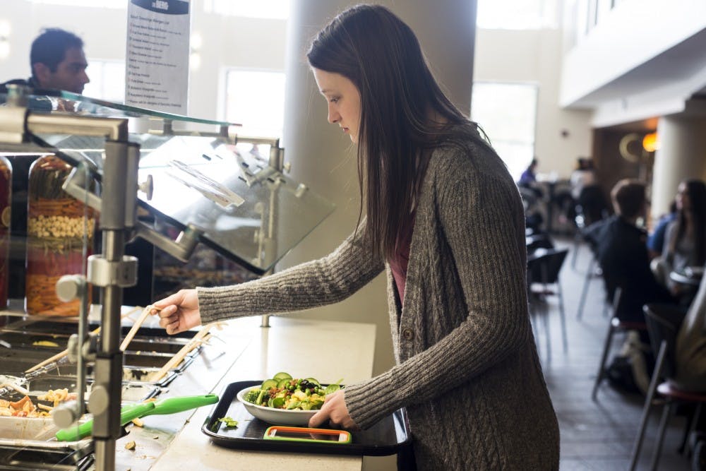 Agribusiness management sophomore Morgan Pish makes a salad for lunch on Jan. 12. 2016 at The Gallery in Snyder-Phillips hall. When asked why she decided to make a salad for lunch, Pish said she feels better when she eats healthy.