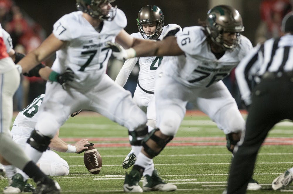 <p>Junior kicker Michael Geiger, 4, kicks the game winning field goal during the game against Ohio State on Nov. 21, 2015 at Ohio Stadium in Columbus, Ohio. The Spartans defeated the Buckeyes, 17-14.</p>