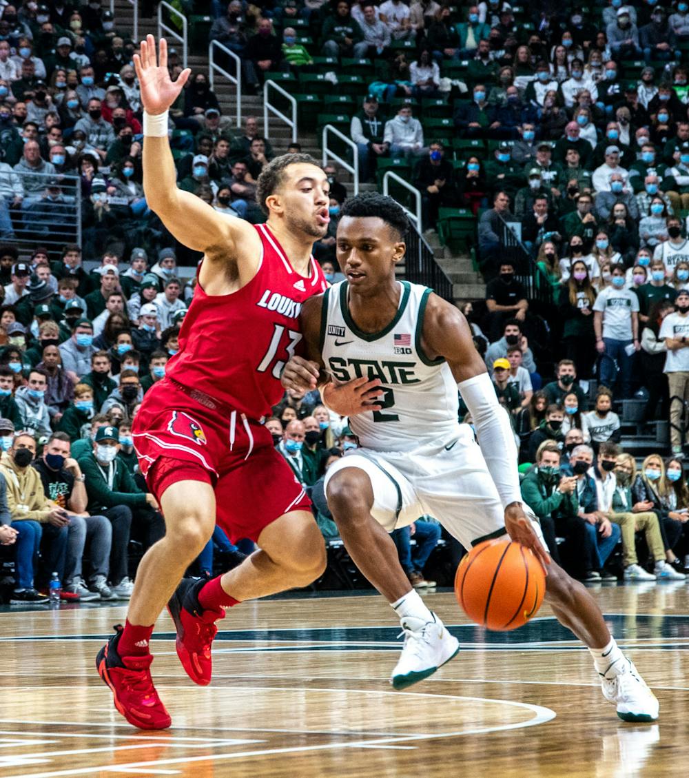 <p>Junior guard Tyson Walker (2) dribbles the ball past Louisville&#x27;s graduate student guard Jarrod West during the first half of the game. The Spartans beat the Cardinals, 73-64, to win the B1G/ACC Challenge on Dec. 1, 2021. </p>