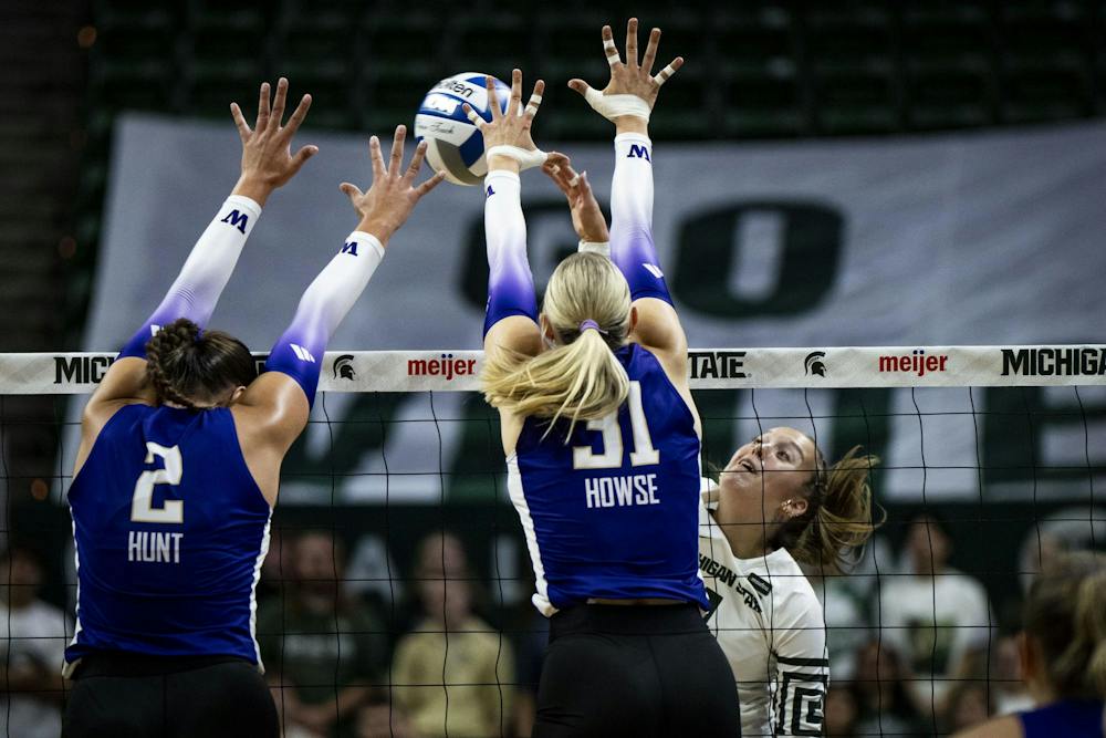 <p>Michigan State senior outside hitter Karolina Staniszewska (2) spikes the ball as Washington junior middle blocker Julia Hunt (2) and sophomore outside hitter Maija Howse (31) attempt to block during a match at Breslin Center in East Lansing, Mich., on Friday, Sept. 25, 2026.</p>