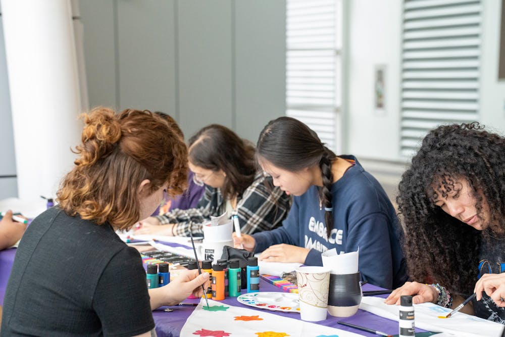 <p>Students paint a bandana during "It's on Us Week," partnering with the Bandana Project to raise awareness for sexual violence on April 5, 2023, in Brody Square Atrium.&nbsp;</p>