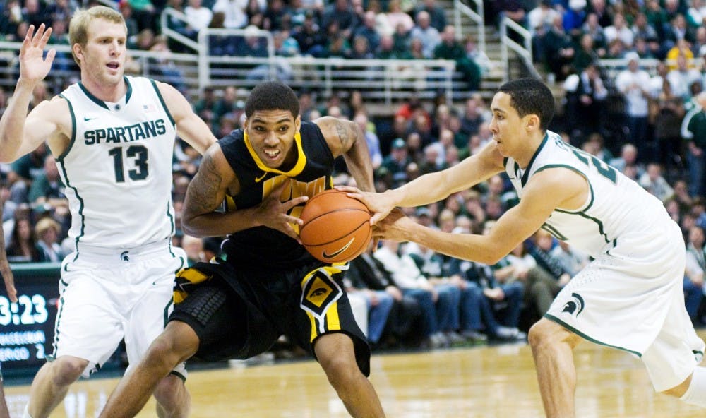 Iowa guard/forward Roy Devyn Marble cannot quite hold on to the ball as freshman guard Travis Trice looks to make a steal. The Michigan State Spartans defeated the Iowa Hawkeyes, 95-61, Tuesday night at Breslin Center. Justin Wan/The State News