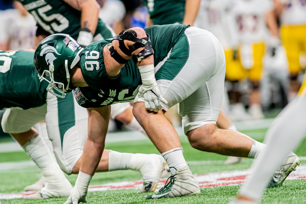 <p>Redshirt senior defensive end Jacob Panasiuk gets set during the Spartans 31-21 victory against Pitt in the Chick-Fil-A Peach Bowl on Dec. 30, 2021.</p>