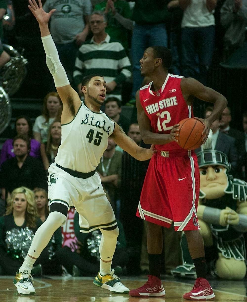 <p>Junior guard Denzel Valentine guards Ohio State forward Sam Thompson Feb. 14, 2015, during the game against Ohio State at Breslin Center. The Spartans defeated the Buckeyes, 59-56. Erin Hampton/The State News</p>