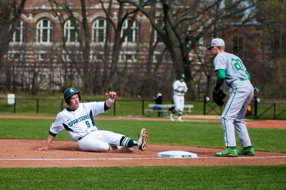 Junior infielder Dan Durkin slides into third base during the game against Notre Dame on April 20, 2016 at McLane Stadium. The Spartans were defeated by the fighting Irish, 1-0.