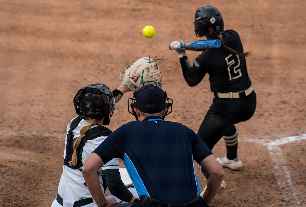 <p>Freshman catcher Macy Lee (10) prepares to catch a pitch in the fourth inning. The Spartans fell to the Golden Grizzlies, 10-5, on April 5, 2022. </p>