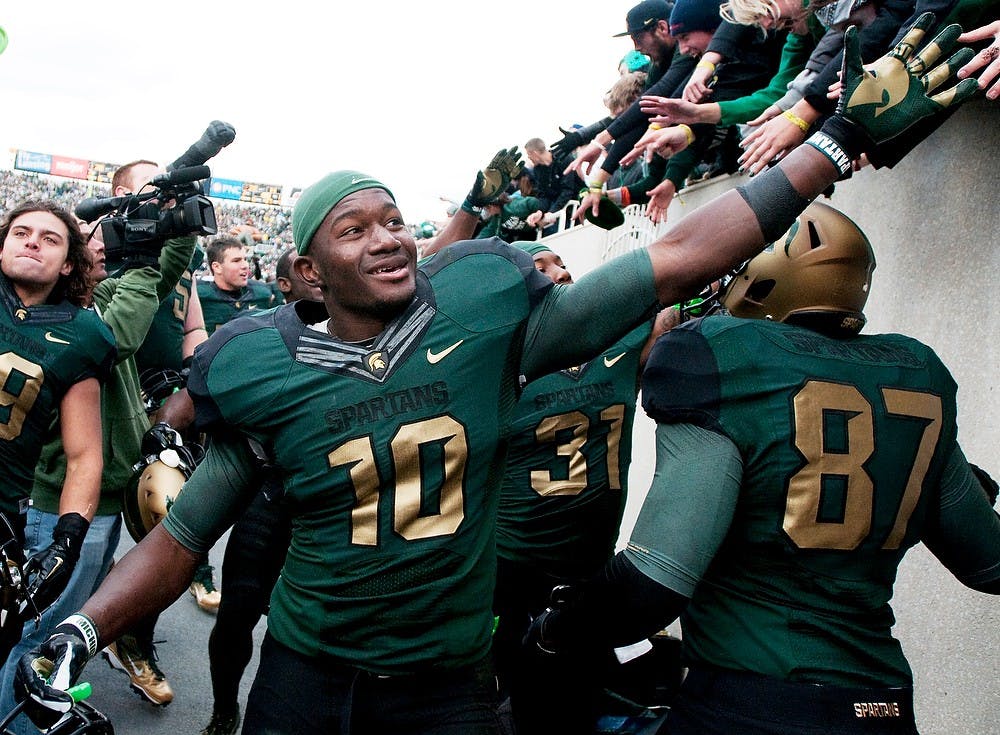 	<p>Junior linebacker Chris Norman celebrates with his teammates and fans after the Spartans defeated U-M, 28-14, on Saturday afternoon at Spartan Stadium. Josh Radtke/The State News</p>