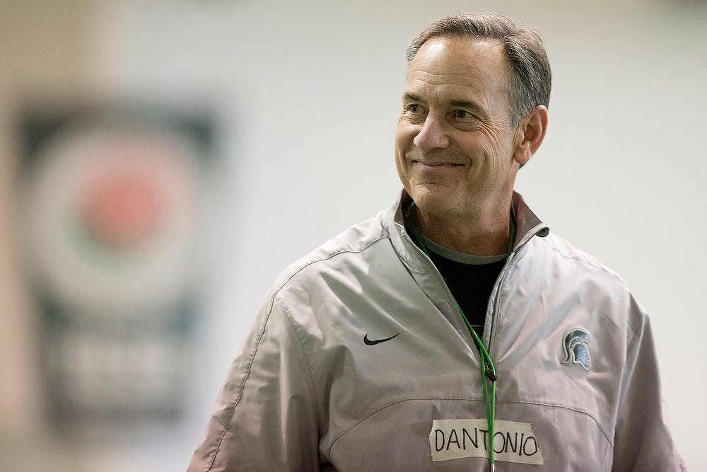 <p>Head coach Mark Dantonio smiles during a practice March 25, 2014, at the practice field inside the Duffy Daugherty Football Building. Julia Nagy/The State News </p>