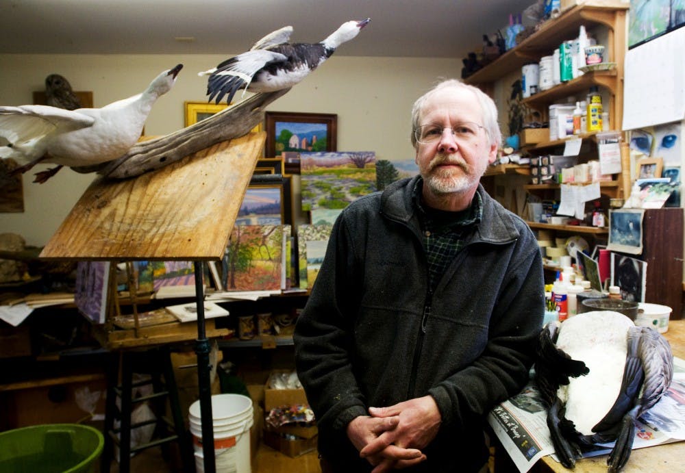 East Lansing taxidermist Charlie Fanta stands in his studio Wednesday afternoon in his workshop. Fanta is an award-winning taxidermist who was honored with the title of Best in World bird taxidermist and won the competitors award, based on the technical skill and artistic merit of four entries. Jaclyn McNeal/The State News