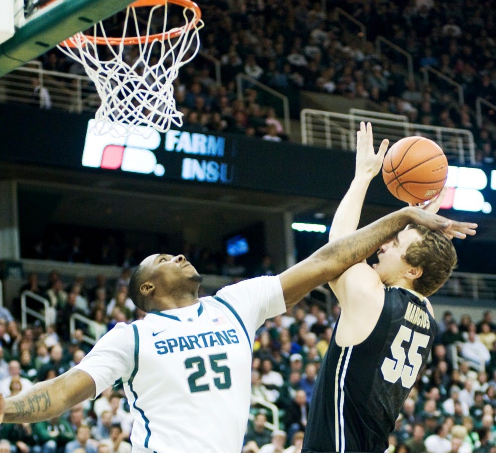 Junior center Derrick Nix attempts to defect the ball by Purdue forward Sandi Marcius, but got his head instead. The Spartans defeated the Purdue Boilermakers, 83-58, Saturday afternoon at Breslin center. Justin Wan/The State News