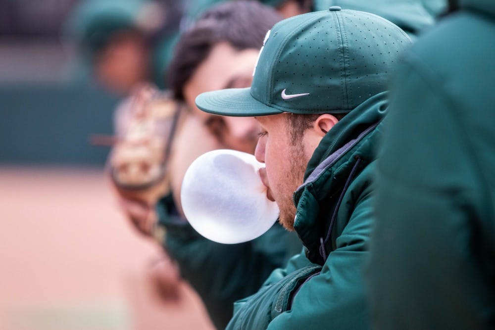 A Spartan blows a bubblegum bubble in the dugout during the game against Notre Dame on April 10, 2018 at McLane Baseball Stadium. The Spartans fell to the Fighting Irish, 8-7.