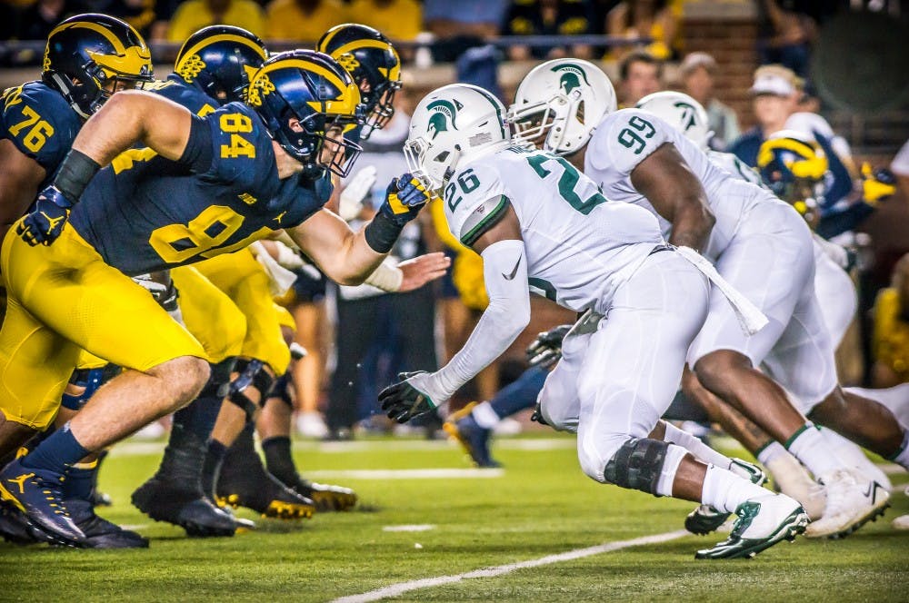 <p>The Spartan defensive line rushes toward the Wolverines during the game against Michigan on Oct. 7, 2017 at Michigan Stadium. The Spartans defeated the Wolverines, 14-10.</p>