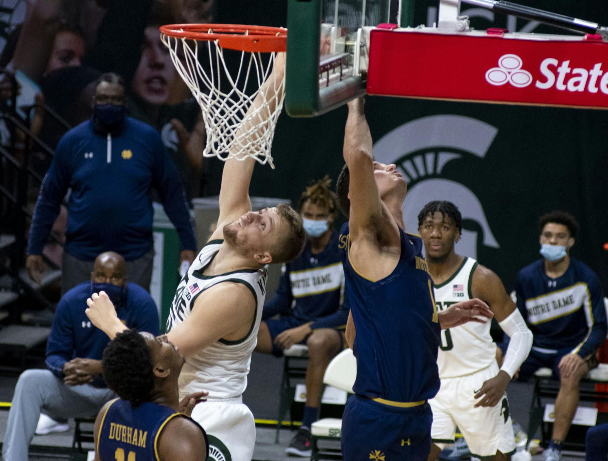 <p>Junior forward Thomas Kithier (15) scores for Michigan State in the first half of the game. Michigan State triumphed over Notre Dame, 80-70, on Nov. 28, 2020. </p>