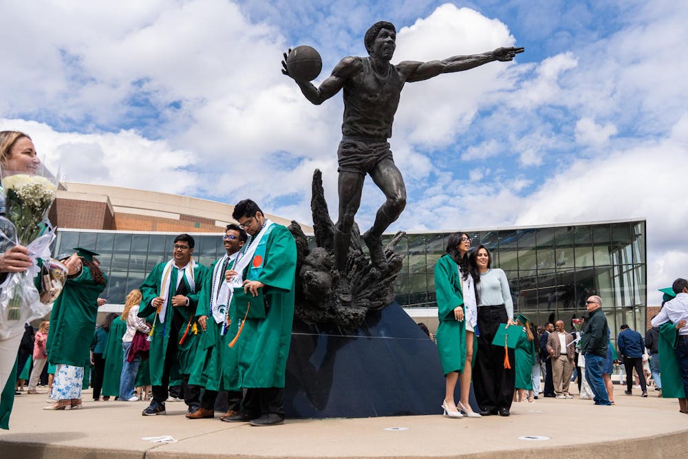 <p>Graduating Michigan State students stand in front of the Magic Johnson statue outside Breslin Center after their convocation in East Lansing, Mich., on May 1, 2026.</p>