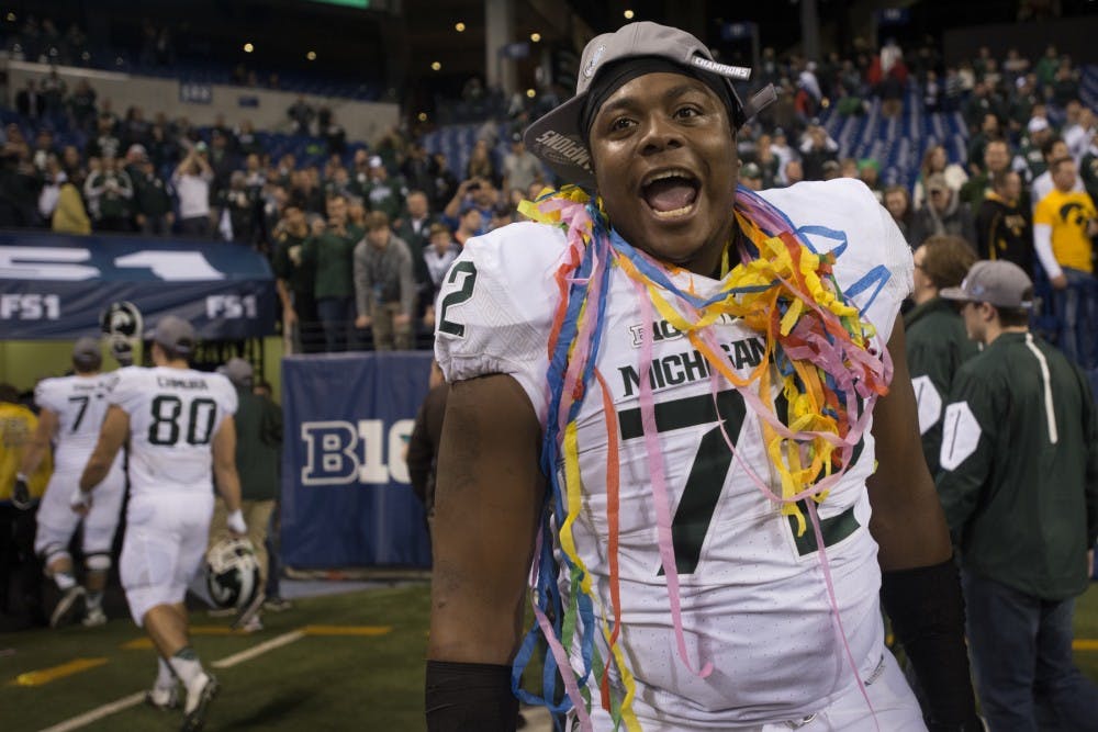 Redshirt freshman defensive tackle Craig Evans celebrates on Dec. 5, 2015 after the Big Ten championship game against Iowa at Lucas Oil Stadium in Indianapolis. The Spartans defeated the Hawkeyes, 16-13.