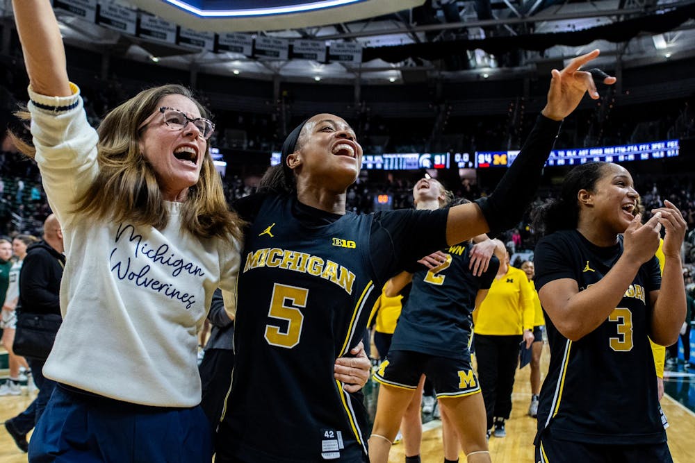 <p>Michigan Wolverines head coach Kim Barnes Arico celebrates with Michigan Wolverines guard Brooke Q. Daniels (5) after the women’s basketball rivalry matchup against Michigan State on Sunday, Feb. 1, 2026 at the Breslin Center in East Lansing. Michigan won in overtime, defeating Michigan State 94-91.</p>