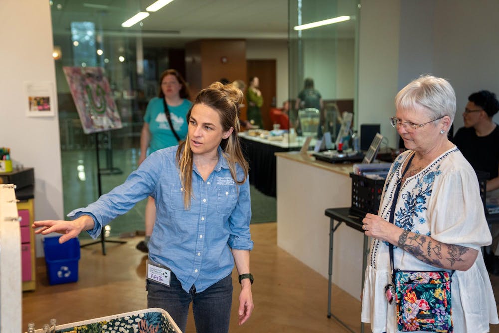 <p>Lead for Spartan Upcycle Katie Deska Radigan explaining a piece to a guest in the Union Art Gallery at the MSU Union in East Lansing on April 21, 2026.</p>