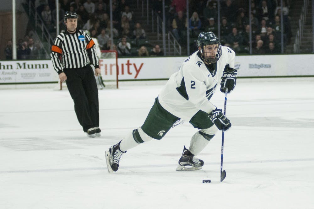 Sophomore defense Zach Osburn (2) looks to pass the puck during the second period of the men's hockey game against Wisconsin on Feb. 3, 2017 at Munn Ice Arena. The Spartans were defeated by the Badgers, 3-6. 