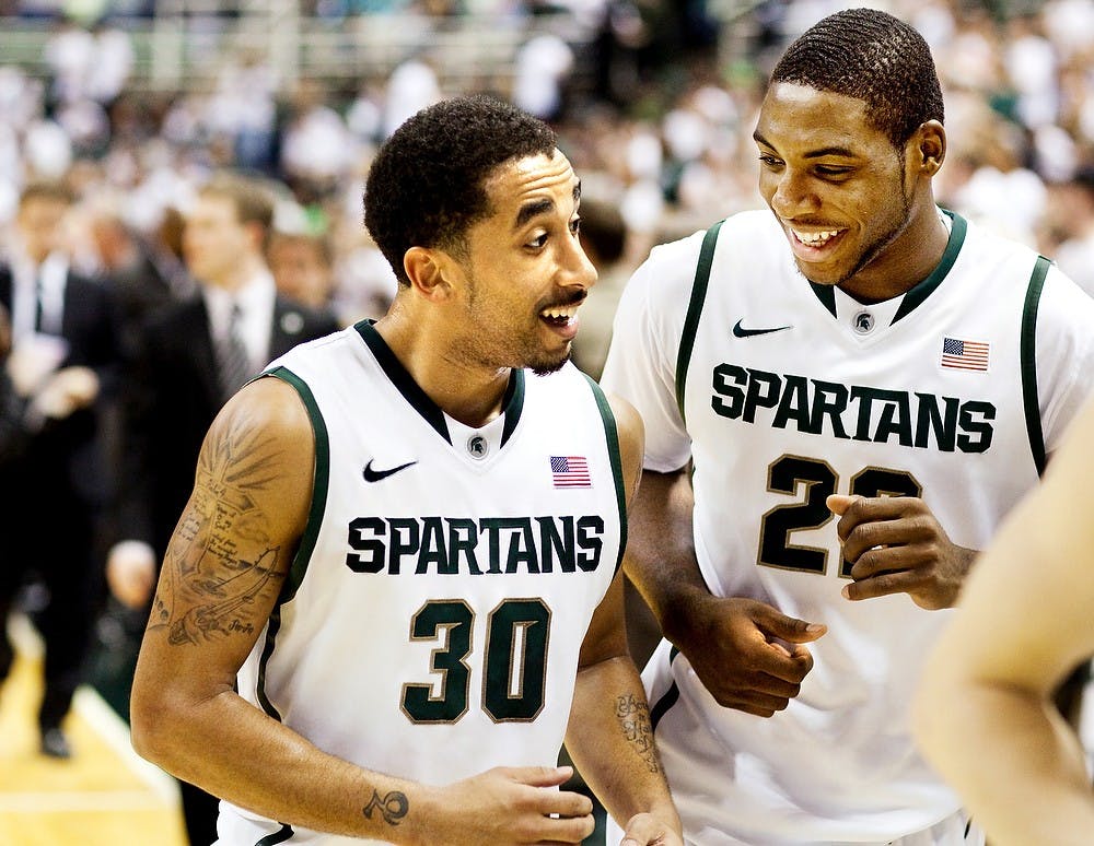 	<p>Then-redshirt senior guard Brandon Wood and then-freshman guard Branden Dawson laugh as they walk off the court following the first half of the Nebraska-Omaha game, Dec. 4, 2011 at Breslin Center. State News File Photo</p>