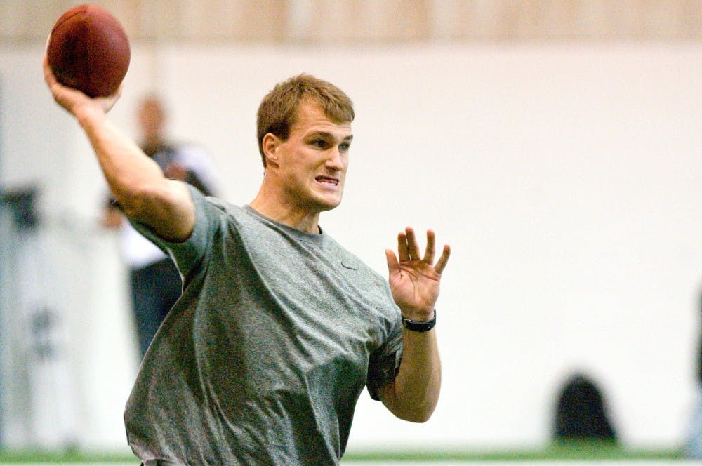 Former MSU quarterback Kirk Cousins participates in pro day drills Wednesday at the Duffy Daughtery Building. Several former MSU football players participated in a pro day session to help NFL scouts evaluate their talent level. Derek Berggren/The State News