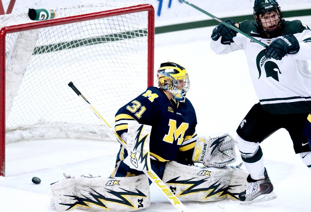 Senior right winger Trevor Nill throws his hands in the air after a goal  is scored on U of M goaltender Shawn Hunwick to tie the game 2-2 Friday night at Munn Ice Arena. The spartans went on to win against the wolverines 3-2 coming back from an early lead by Michigan. Aaron Snyder/The State News.  