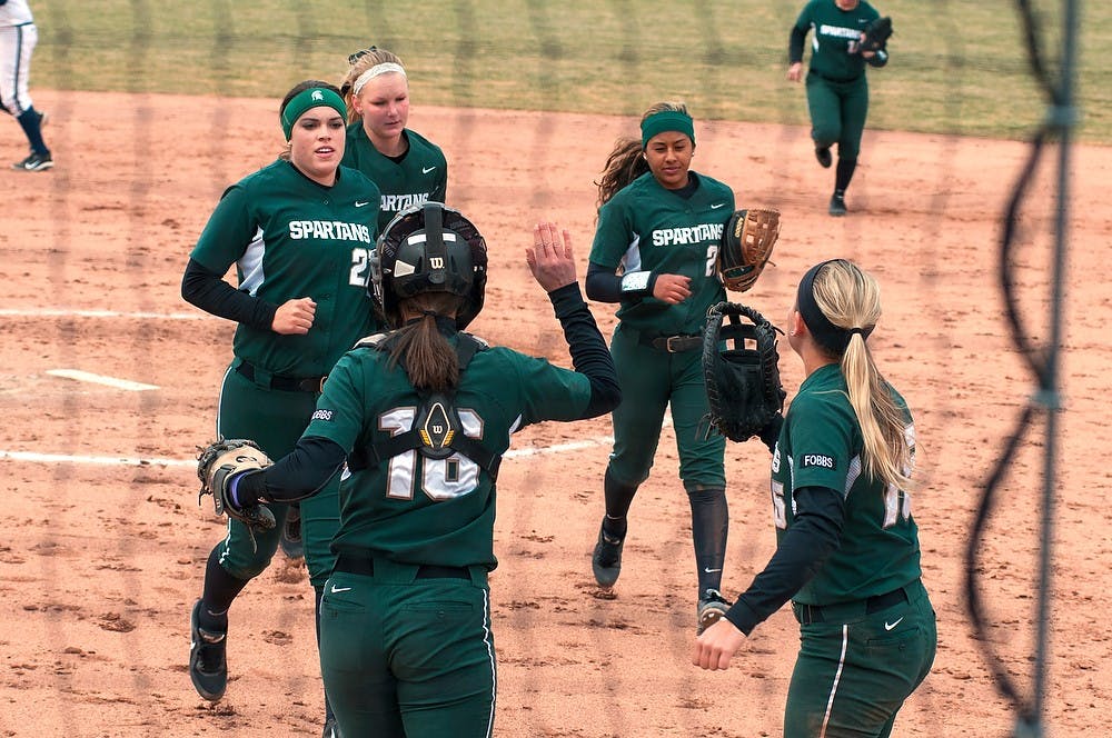 <p>The team celebrates a good inning March 29, 2015, during the softball game against Penn State at Secchia Stadium. The Spartans defeated the Nittany Lions 8-6. Hannah Levy/The State News</p>