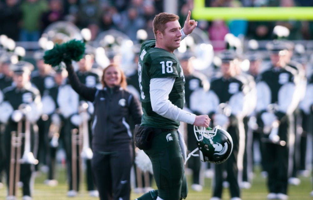 Senior quarterback Conner Cook, 18, runs onto the field during the seniors special introductions before the game against Penn State on Nov. 28, 2015 at Spartan Stadium. The Spartans defeated the Nittany Lions, 55-16.