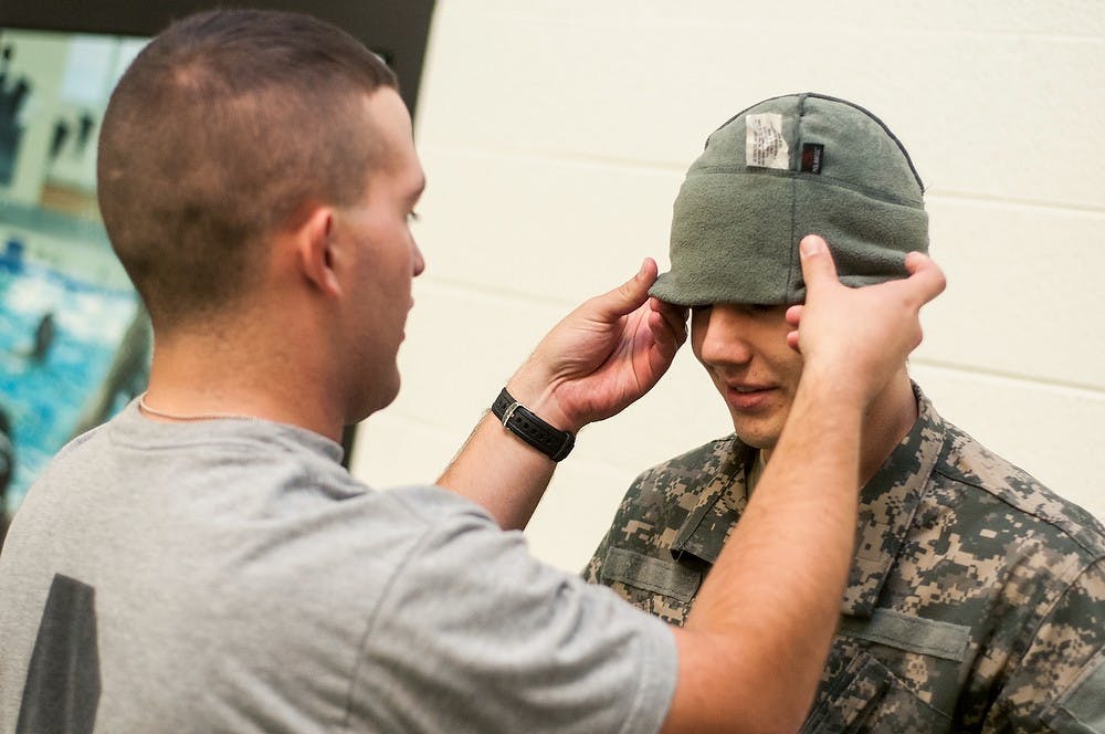 	<p>Criminal justice senior James Starkey blindfolds criminal justice junior Josh Favaloro during the annual Combat Water Survival Test on Oct. 29, 2013, at IM Sports-West. Cadets had to take blindfolded jumps and complete various swimming tasks. Khoa Nguyen/The State News</p>