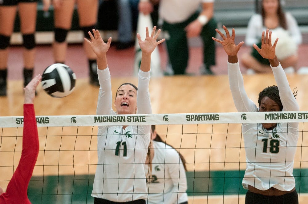 	<p>Freshman outside hitter Chloe Reinig and senior middle blocker Alexis Mathews, 18, go up to block Nov. 1, 2013, during the game against Ohio State at Jenison Field House. The Spartans defeated the Buckeyes, 3-0. Julia Nagy/The State News </p>