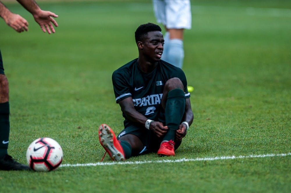 Freshman forward Farai Mutatu (9) ties his shoe during the game against Tulsa on August 26, 2018 at DeMartin Stadium. The game ended in a draw between the Spartans and the Golden Hurricanes. 