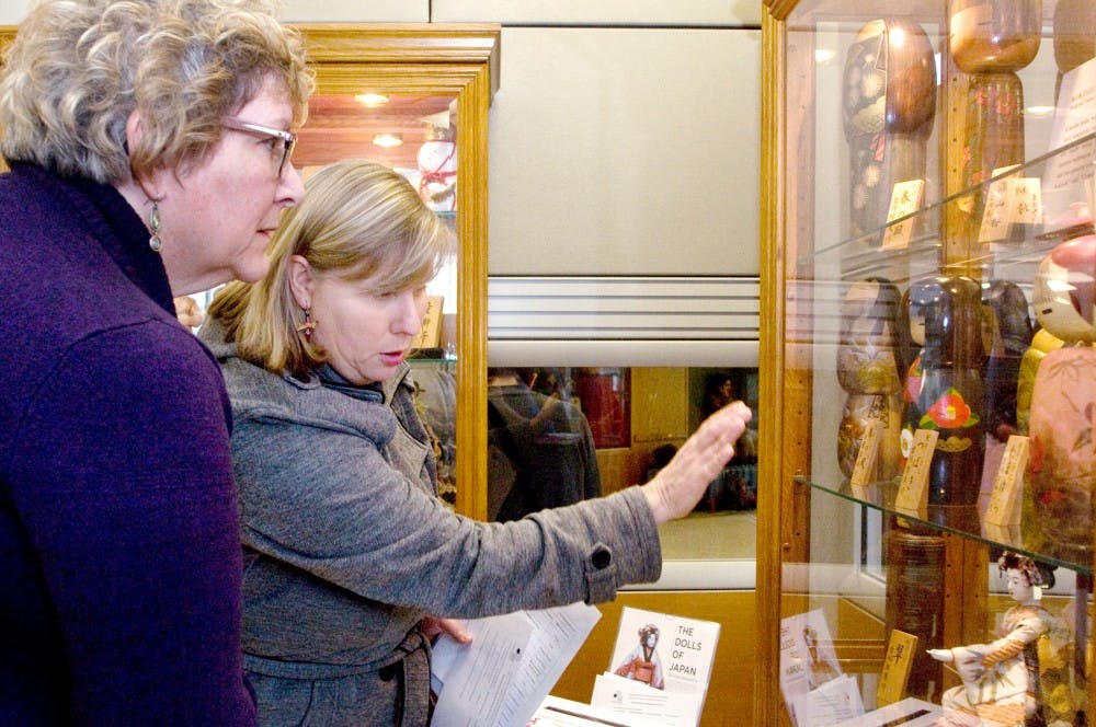 From left to right, Ovid, Mich. residents Linda Beeman and Steveanna Roose view Japanese dolls Monday in the International Center. The Dolls of Japan exhibit helps visitors appreciate various aspects of Japanese culture. Derek Berggren/The State News