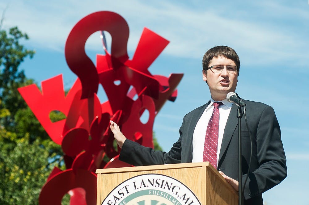 	<p>East Lansing Mayor Pro Tem Nathan Triplett addresses the crowd during the Raising Harmony sculpture dedication in honor of former Councilmember Mary P. Sharp, Sept. 6, 2013, in front of City Hall, 410 Abbot Road. Danyelle Morrow/The State News</p>