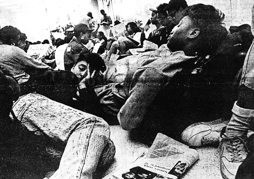 Tired protestors at the 2-day-old-sit-in try to rest their eyes after a long night at the Administration Building.