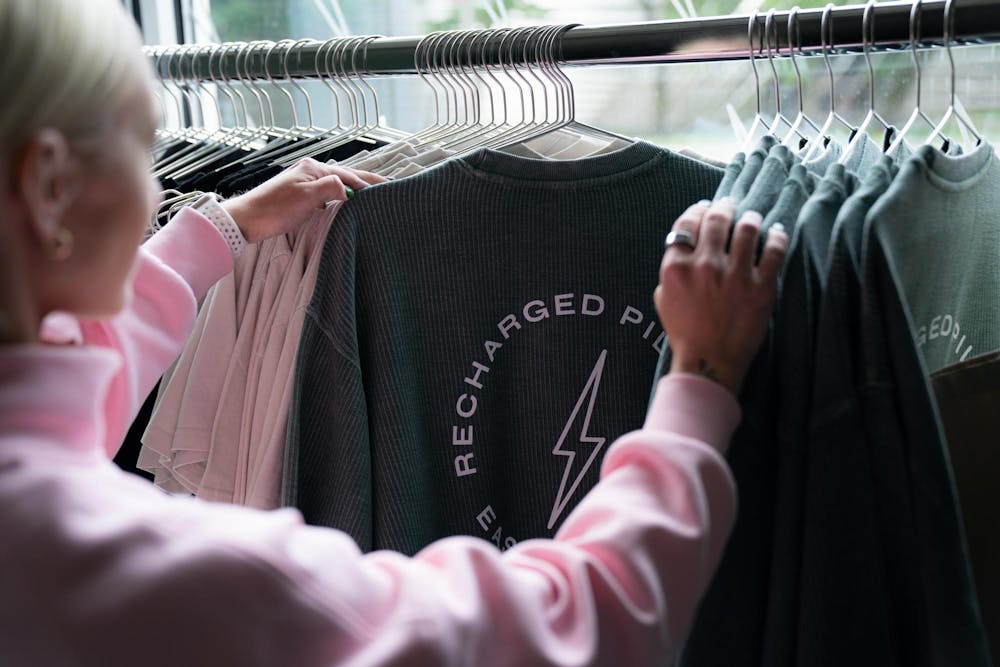 Olivia Harris stocks t-shirts at Recharged Pilates on June 12, 2025. 