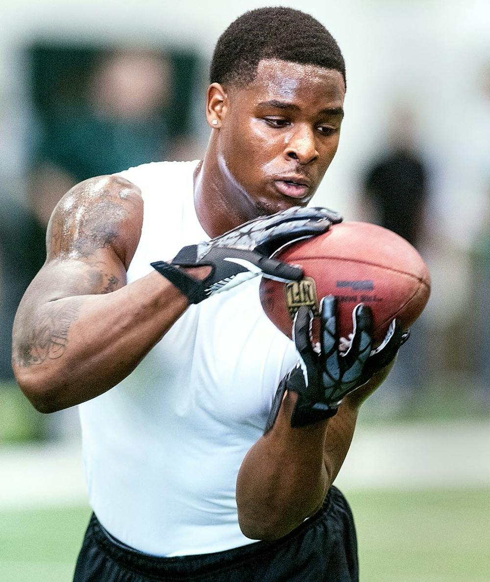 Junior running back Le'Veon Bell catches a pass during a drill March 13, 2013, during Pro Day at the Duffy Daugherty Football Building. MSU football holds the annual event for NFL scouts and coaches to get a closer look at the Spartans' NFL prospects. Adam Toolin/The State News