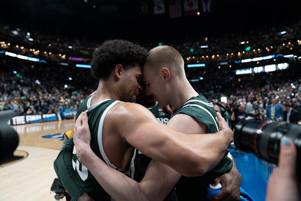 <p>Senior forward Malik Hall, graduate student forward Joey Hauser and junior center Mady Sissoko embrace at Nationwide Arena on March 19, 2023, during the second round of the NCAA tournament. Michigan State defeated Marquette 69-60 to advance to the Sweet 16.</p>
