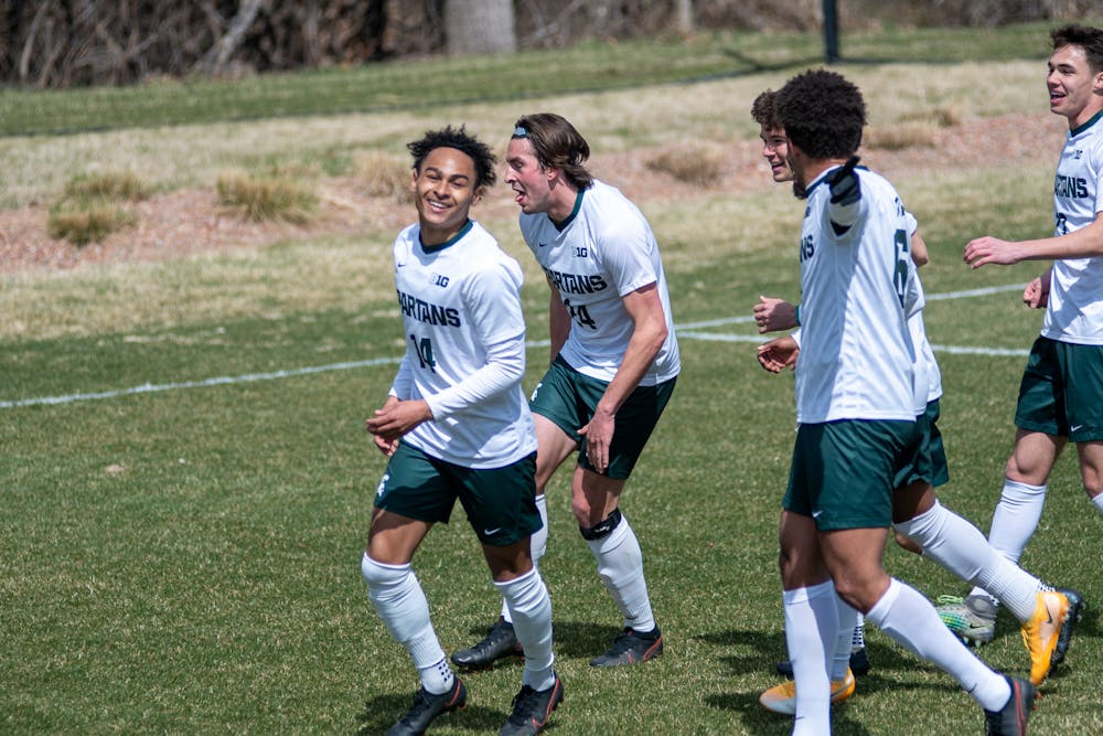 Members of Michigan State men's soccer team celebrating after the first goal in the game against Wisconsin on March 31st, 2021 at DeMartin Stadium in East Lansing.