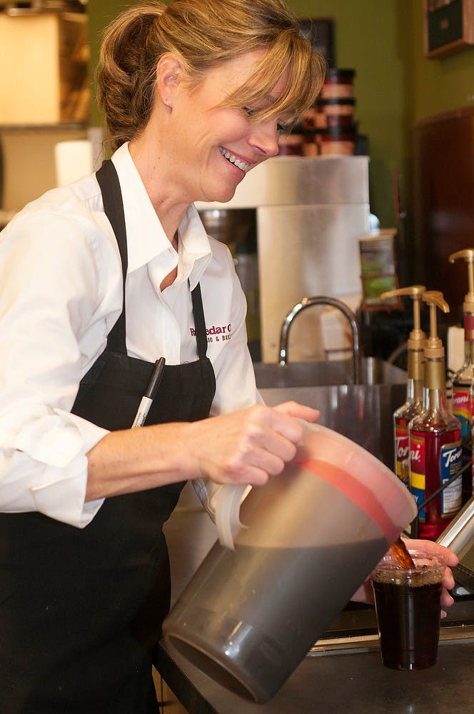 	<p>Owner Angie Anderson pours a cup of iced coffee Nov. 21, 2013, at the Red Cedar Cafe, 1331 E. Grand River Ave. Anderson is very active at the restaurant with making drinks, working at the counter and interacting with her usual customers.</p>