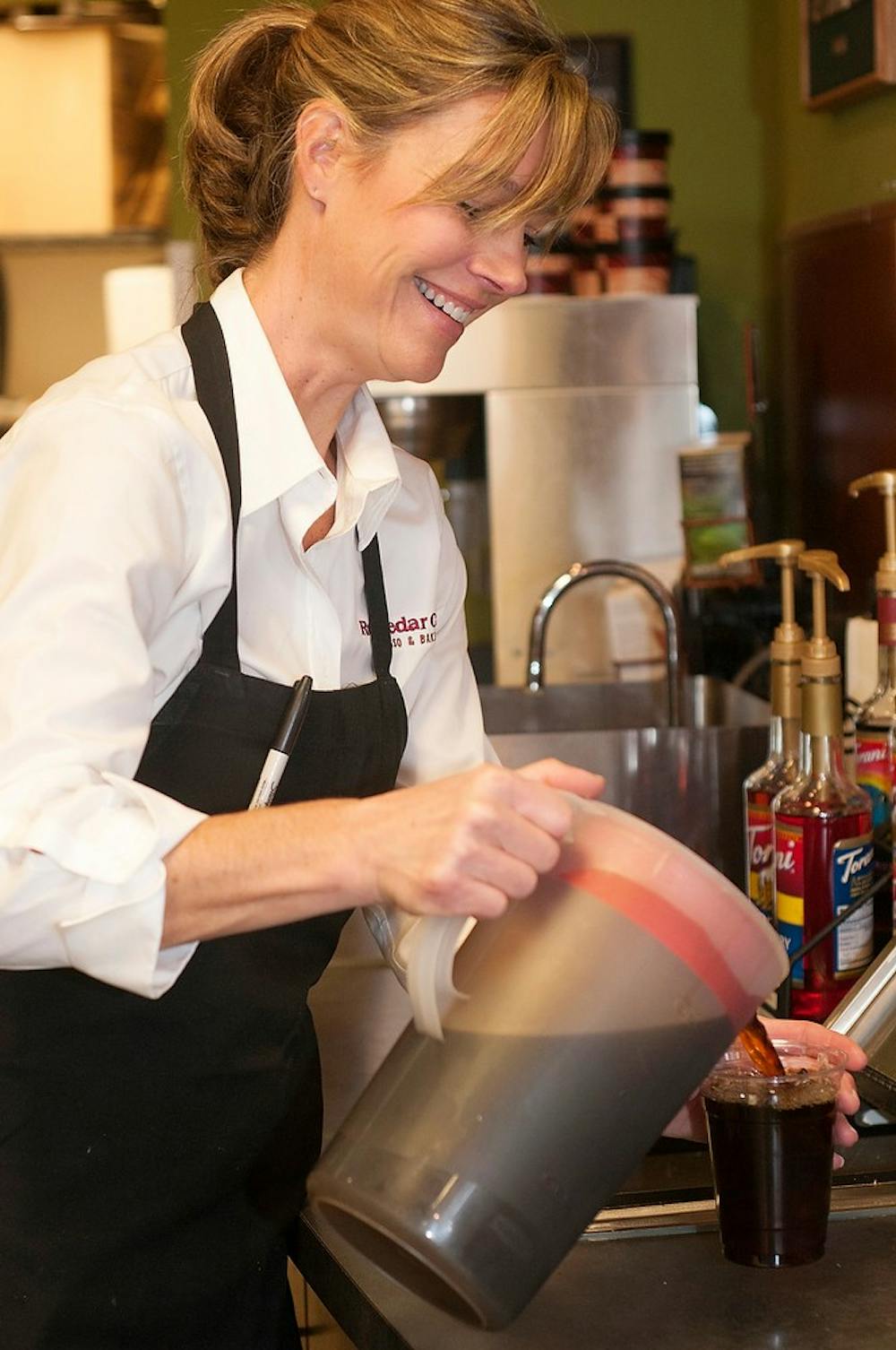 	<p>Owner Angie Anderson pours a cup of iced coffee Nov. 21, 2013, at the Red Cedar Cafe, 1331 E. Grand River Ave. Anderson is very active at the restaurant with making drinks, working at the counter and interacting with her usual customers.</p>