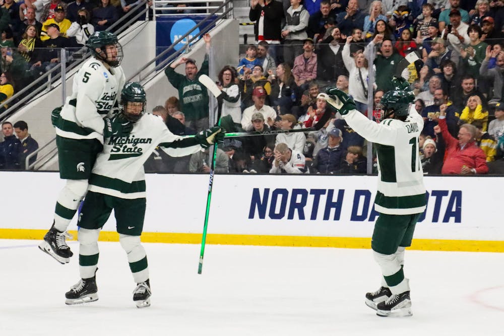 <p>Senior forward No. 11 Jeremy Davidson, freshman defenseman No. 5 Artyom Levshunov and sophomore forward No. 18 Joey Larson gather after an MSU goal in the NCAA Regional game against Michigan at Centene Ice Center on March 31, 2024.</p>